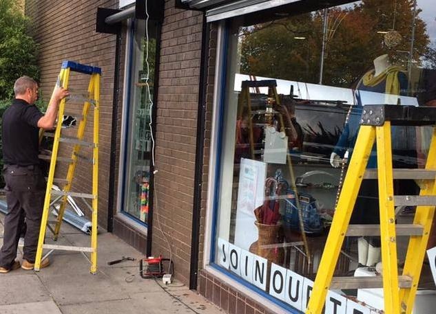 Company Alpine Security Systems install free roller shutters at Dr Kershaw's Hospice Shop, Chadderton Precinct, Middleton Road, following a break in during October which left the shop with thousands of pounds of damage
