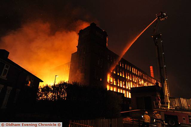 Taking hold... the blaze tears through Maple Mill in Hathershaw early this morning