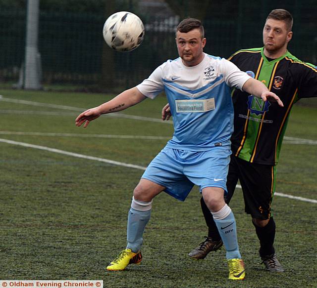 BACK OFF . . . Heyside's Mark Hopwood shields the ball from an Atherton opponent