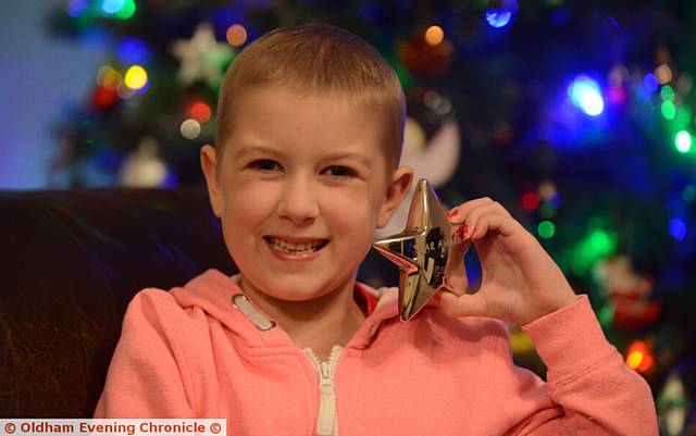 LITTLE smiler . . . six year old Esme Fryer with her Star award