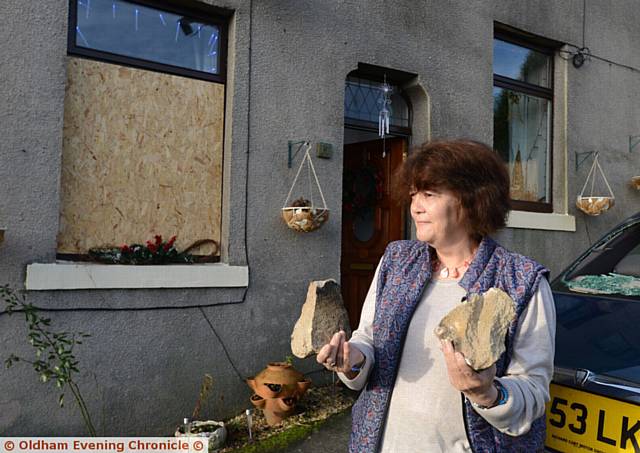 RESIDENT Isabel Furness holding stones used to attack car and house windows in Webster Street, Mossley
