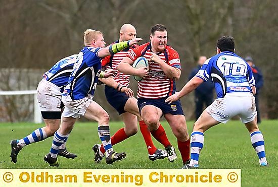 ON THE CHARGE . . . the outstanding Tom Hannon bursts through Tyldesley challenges.