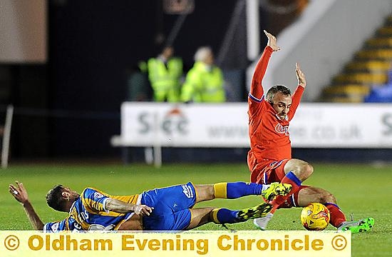 SLIDE SHOW: Liam Kelly feels the force of a strong challenge from former colleague Richie Wellens

