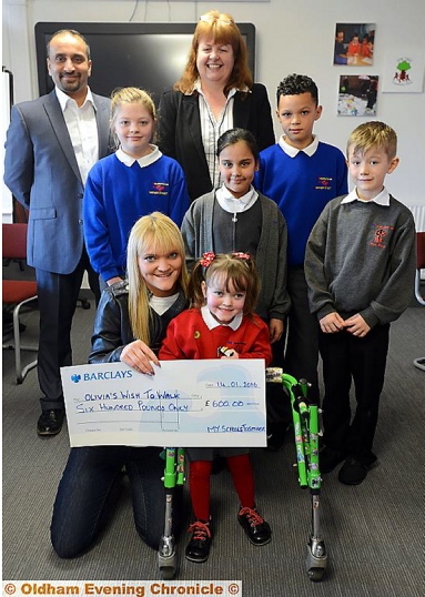 MAKING a wish come true . . . Olivia Berry and mum Christie Kindon receive the donation. Back, from left, Rais Bhatti (head of school, Yew Tree), Eleanor Riley (Mather Street), Sally Brown (head of school Mather Street), Hannah Ahmed (Yew Tree), Nico O’Reilly (Mather Street) and Liam Vickery (Yew Tree)