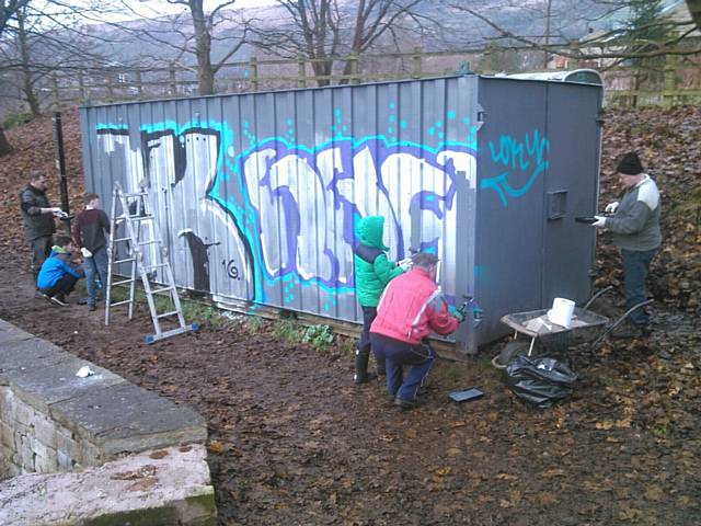 VOLUNTEERS help to repaint the vandalised storage cabin beside the Standedge Canal tunnel.