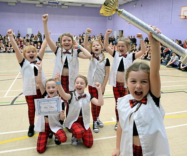 OLIVIA Hamilton (6) raises the trophy for 10s and under winners Bad Attitude at last year's Oldham Street Dance Championships at The Oldham Academy North