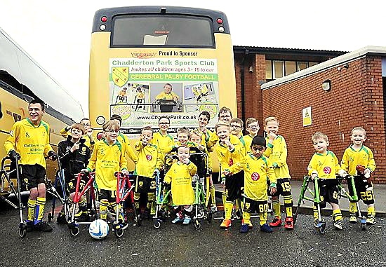 COME on you Yellows . . . Chadderton Park Cerebral Palsy team in front of the coach featuring the club.