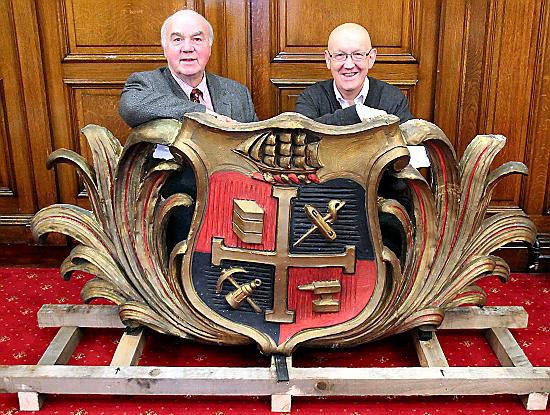 RESTORED . . . Councillor Graham Shuttleworth (left), chair of Chadderton District Executive, and Chadderton Central councillor Eddie Moores, deputy cabinet member for economy and enterprise, with the restored Chadderton crest, and (below) the current crest
