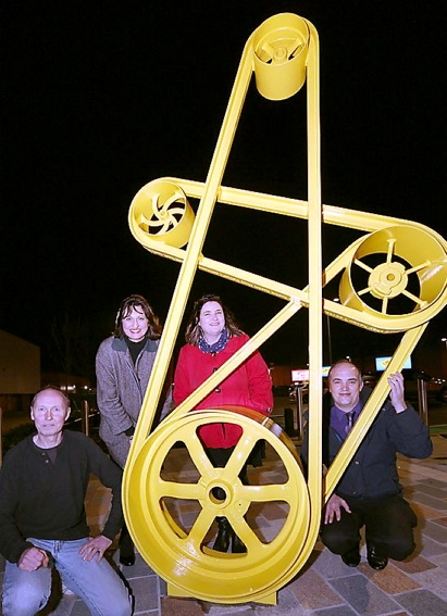 Elk Mill’s “belts and pulleys” artwork. Pictured: Andy Stafford, artist Emma Hunter and writer Cathy Crabb, with park manager Derek Askew