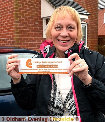Angela Armitage with the car stickers she and friend Carole Aitken have funded in memory of their husbands Eric and Geoff