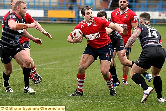 WATCH OUT . . . Oldham’s Phil Joy looks for a gap against the Broncos.