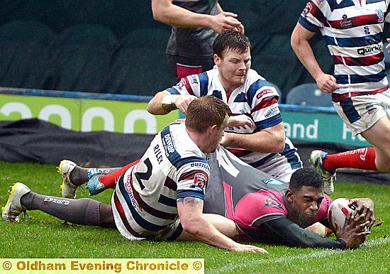 OFF THE MARK . . . Jamel Chisholm slides in to score his first try in Roughyeds colours.
