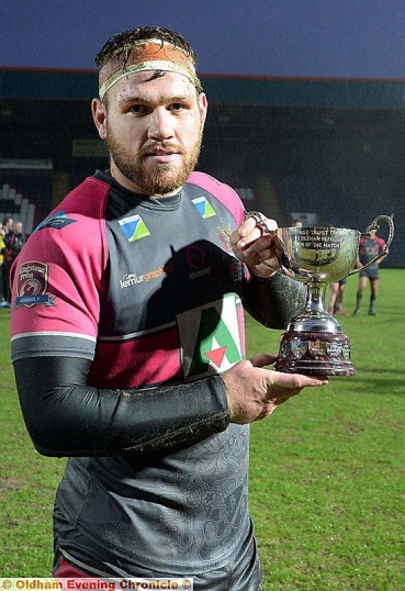 STAR TURN . . . Josh Crowley shows off the Oldham RL Heritage Trophy after being named man-of-the-match.
