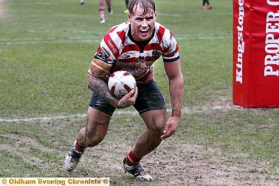 MUDDY MARVEL . . . Oldham’s Danny Langtree shows his delight after diving in for a try against Dewsbury Rams. PICTURE: PAUL STERRITT