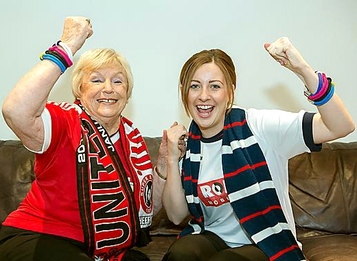 Charity volunteer Sheila Crompton and senior cancer awareness nurse Jessica Turner put aside football allegiances to unite for World Cancer Day