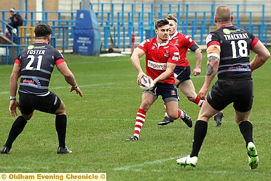 FIND A MAN . . . Oldham skipper Lewis Palfrey looks to offload the ball. 