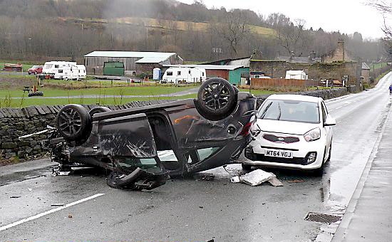 A Vauxhall Corsa lays on its roof after control was lost and it hit a stone wall at Well-I-Hole Road, Greenfield. 