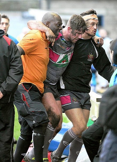 INJURY BLOW . . . Craig Briscoe is helped from the field at Barrow.