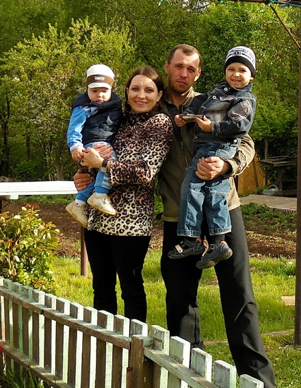 AT home in Belarus, Marina with her husband, Aleksai and their sons Pavel (left) and Dmitry