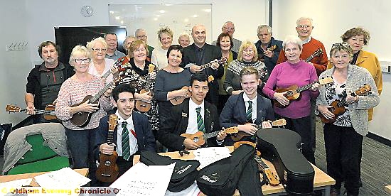 Waterhead Academy students (from left) Sam Castillo, Sam Kirk and Matthew Vincent help tutor Glen Malowney (centre back) with the University of the Third Age ukulele group