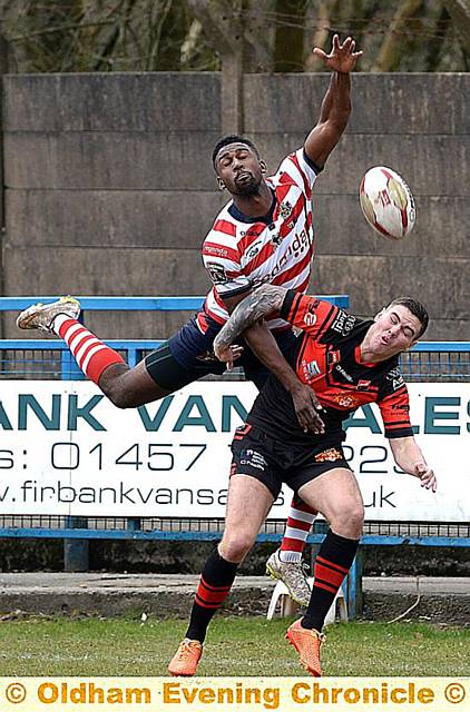 LOOK BEFORE YOU LEAP: Oldham’s Jamal Chisholm takes to the air to try to win possession. PICTURES by TIM BRADLEY

