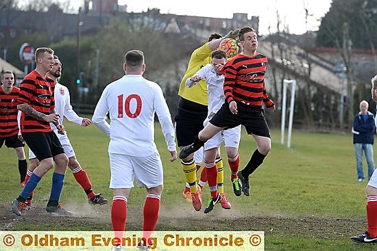 UP FOR IT . . . Oddies’ Danny Smith (stripes, right) goes for a header as John Gilder (far right) looks on.