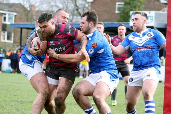 NO WAY THROUGH . . . Sammy Gee finds his path to the line blocked by Swinton Lions defenders. 