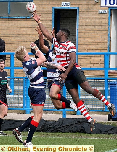 OLDHAM winger Jamel Chisholm (right) takes a leap.
