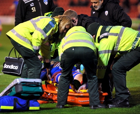 BAD NEWS: stricken Brian Wilson is helped on to a stretcher.