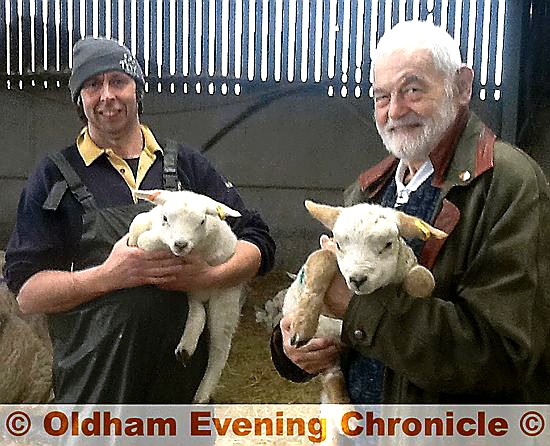 LAMBING season...Darren Hough with his father Bryn and some of the new borm lambs.
