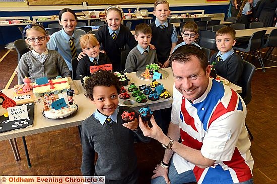 Bake-off and coffee morning at St. Mary's CE Primary School High Crompton, with celebrity chef Andrew Nutter judging the children's cakes. Pictured with Andrew are the winners, including Jayden Marsland (6)
