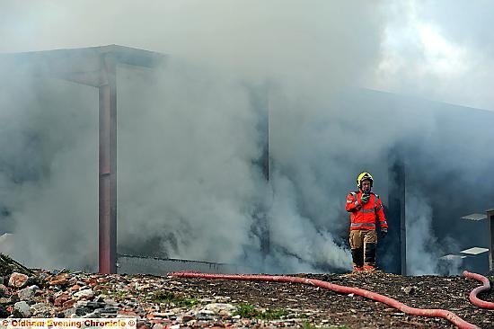 A firefighter at the fire on Round Hill Farm, Dobcross.
