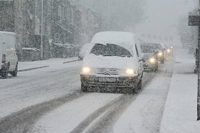 MOVING slowly... commuters battle through this morning's snowfall in Springhead