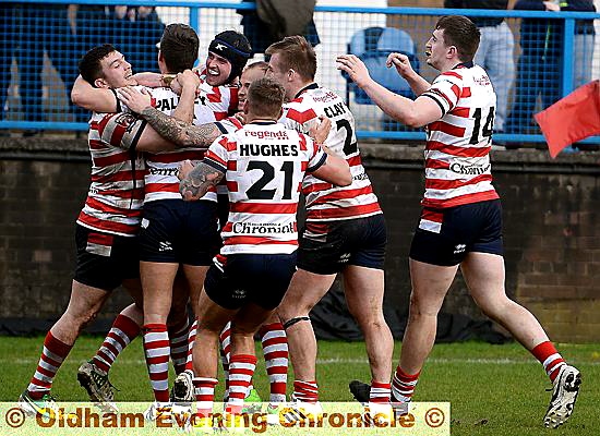 MILES OF SMILES . . . Liam Johnson (third, left) is mobbed by his team-mates after scoring Oldham’s second try in the defeat of Batley Bulldogs at Bower Fold. 
