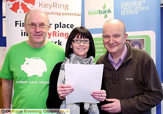 FUNDING boost: (from left) Gordon Roscoe, from CAP Oldham management committee; Claire Gleeson, North-West manager for Keyring; and Andrew Barr, Oldham Food Bank ,with the letter confirming funding