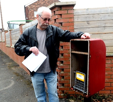 Chadderton resident Neil Whyatt finds what is left of the postbox in Queen’s Road after thieves struck