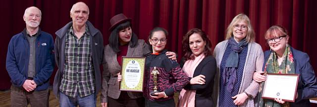 The second Sahar International Short Film Festival, at Gallery Oldham. Festival director Mandana Ansari is in the centre, with Niki Mandegar, who won a best child actor award for Mandana's own film, Lonely Continent, surrounded by other audience members.