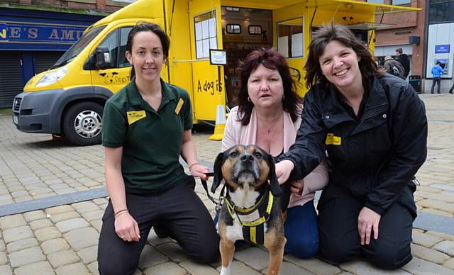 Dogs Trust Dogmobile visits Oldham town centre to raise funds for the Dogs Trust Manchester Rehoming Centre. Left to right, Mel Bannister (rehoming centre), Janice Haskins, Laura Nicholas (Dogmobile asst. manager). And Noel the dog in foreground.