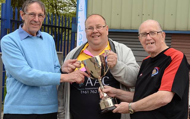 HANDOVER . . .Geoff Cooke, chairman of Rugby Oldham, presents the Rugby Oldham Challenge Trophy to David Hughes (centre), head coach of Fitton Hill, and club chairman John Hughes.