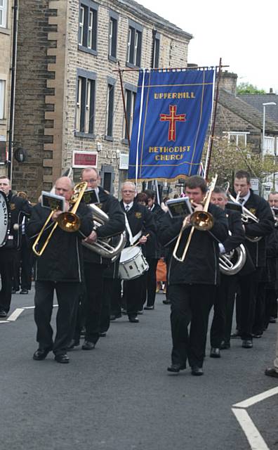 Whit Friday walks in Uppermill.  Uppermill band marching through the village. 