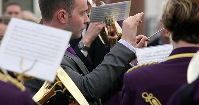 Whit Friday brass band contest at Grotton. Jonathan Davies, conducting Delph brass band at Scouthead.