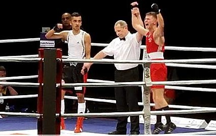Moment of glory . . . Oldham Boxing's Will Cawley (right) celebrates his brilliant victory in Liverpool.