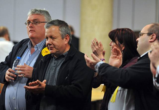 VETERAN Lib-Dem Councillor Howard Sykes (left) gets applause from Councillor Chris Gloster and other supporters after retaining his Shaw seat.

