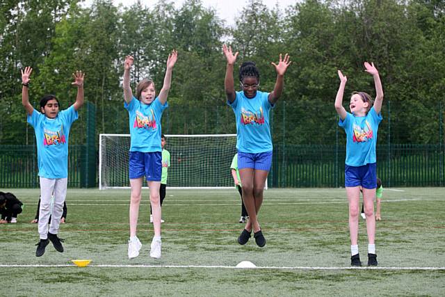 School students from around Oldham gathered at Hathershaw college to practice their dance routine for the rugby league summer bash in Blackpool, they will be dancing at the summer bash where Oldham rugby league club will be playing. L/R, Ikra Amed, aged 10, Isabelle Isard, aged 11, Laura Isaac, aged, 10, Caitlin Heywood, aged 10, practising their routine.