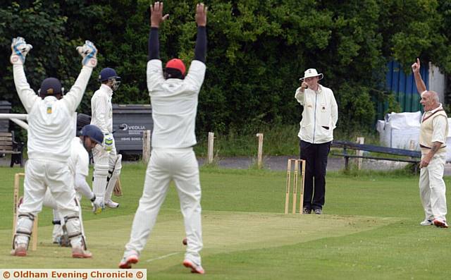 THAT'S OUT . . . Mel Whittle, playing for Hollinwood, traps Shaw's Saim Ghouri leg before wicket in the Tanner Cup clash at Lime Lane. 
