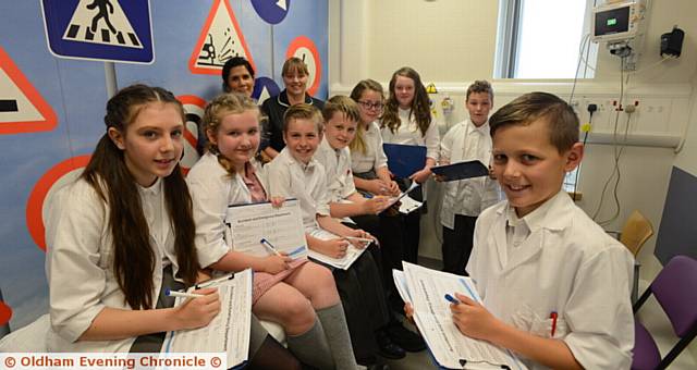 MAKING notes . . . from left, Destiny Clifford, Freya Hilton, Alex Dowd, Connor Beech, Ruby Adams-Jones, Vienna McCampbell, Cameron Smith, Ryan Frost. Standing behind the pupils are Dianne Cook (lead advanced paediatric nurse practitioner), left and Julie Winterbottom (clinical matron).