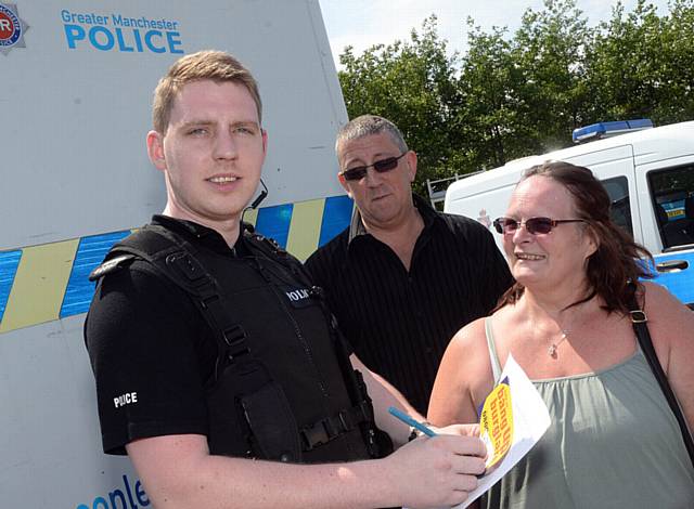 Mobile Police Station at Tesco, Oldham. Special Sergeant Benjamin Howarth talks to locals Nick Dobbs and Jean Dobbs