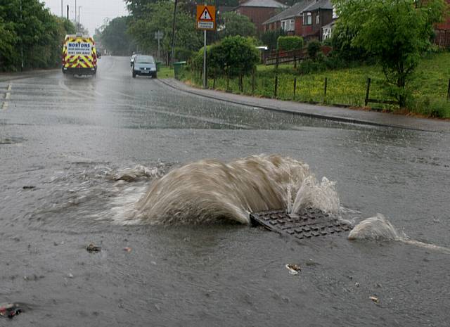 Heavy rain caused the cover of a storm drain to lift on Foxdenton lane, heading towards Grimshaw Lane. This causing flooding of the road.