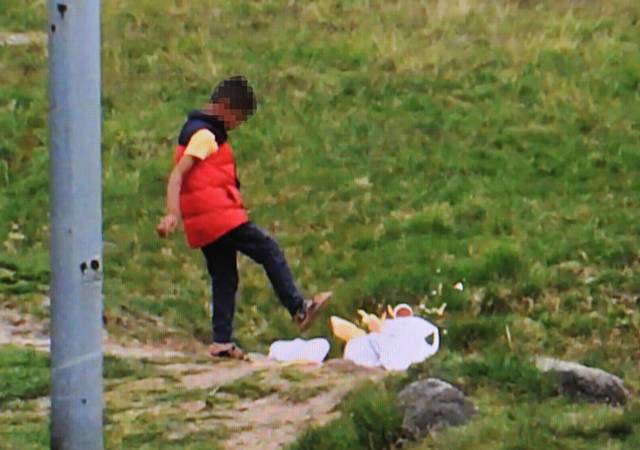 Video still of a boy kicking litter at Dovestone Reservoir recently.