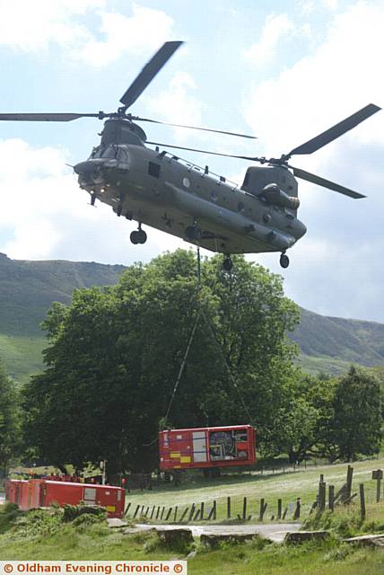 Exercise Triton at Dovestone Reservoir, involving all the major services including the Army, police, fire and rescue service, United Utilities and others. Pic shows Chinook helicopter dropping off  a water pump.